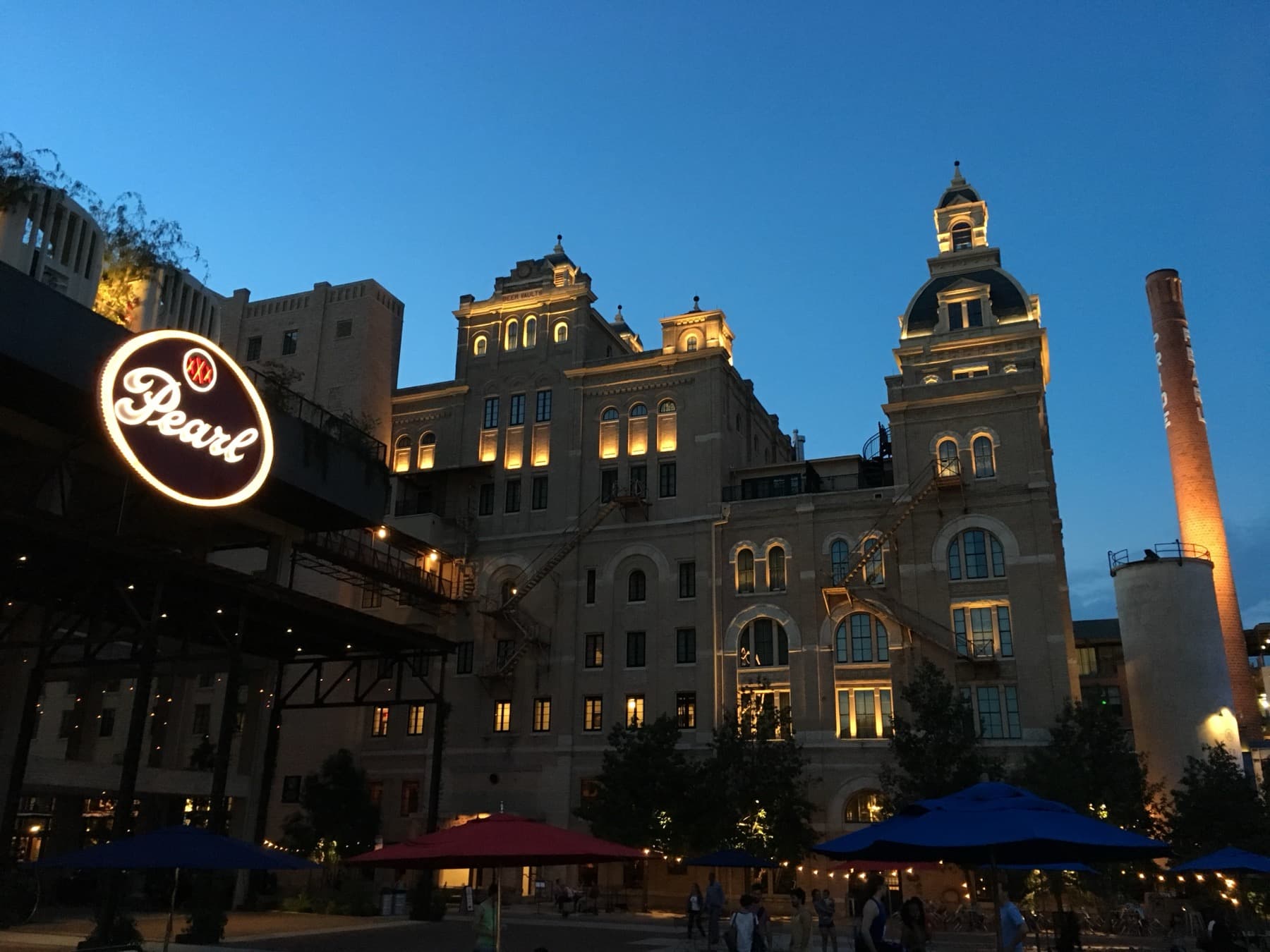 The Pearl Brewery district illuminated at dusk in San Antonio